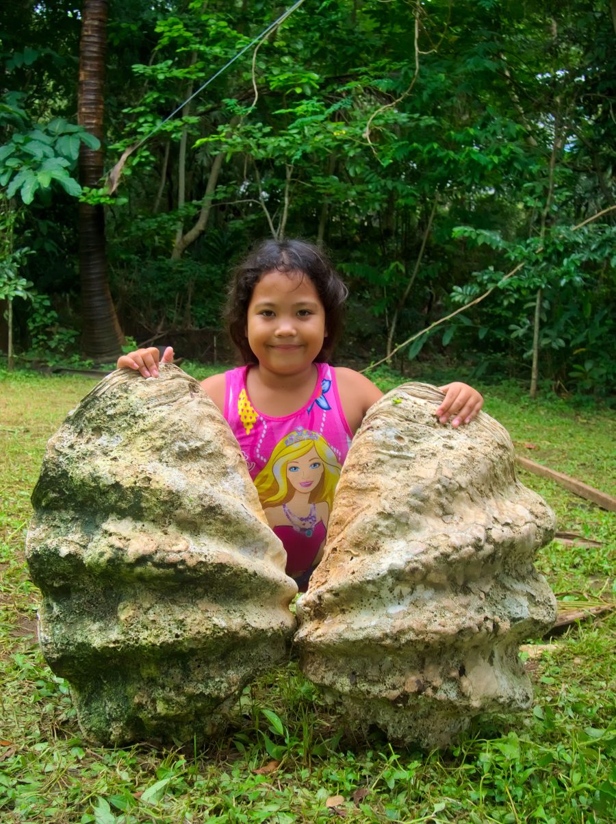 girl and giant clam shell