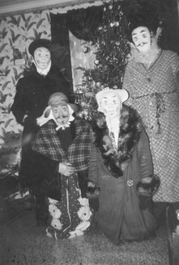 Mummers wear their “false faces” in Winterton, Newfoundland and Labrador, in 1958. Photo courtesy of the Wooden Boat Museum of Newfoundland and Labrador