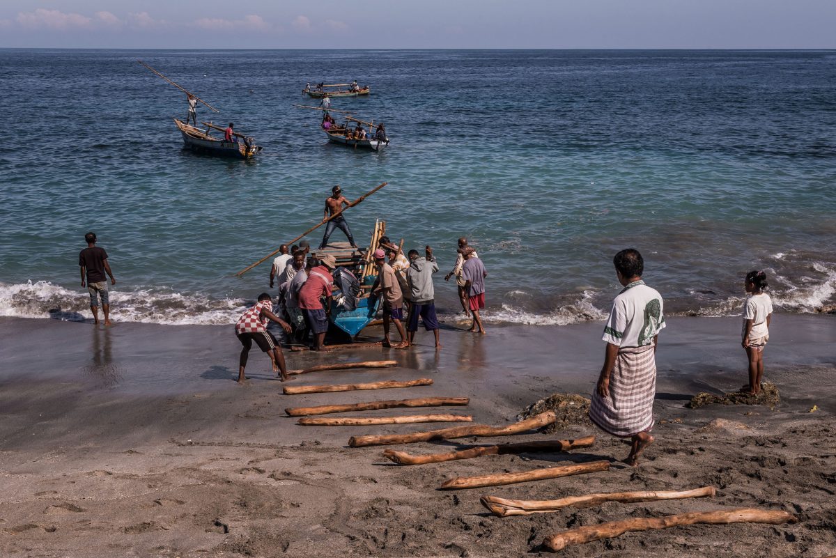 Villagers launch a fishing boat