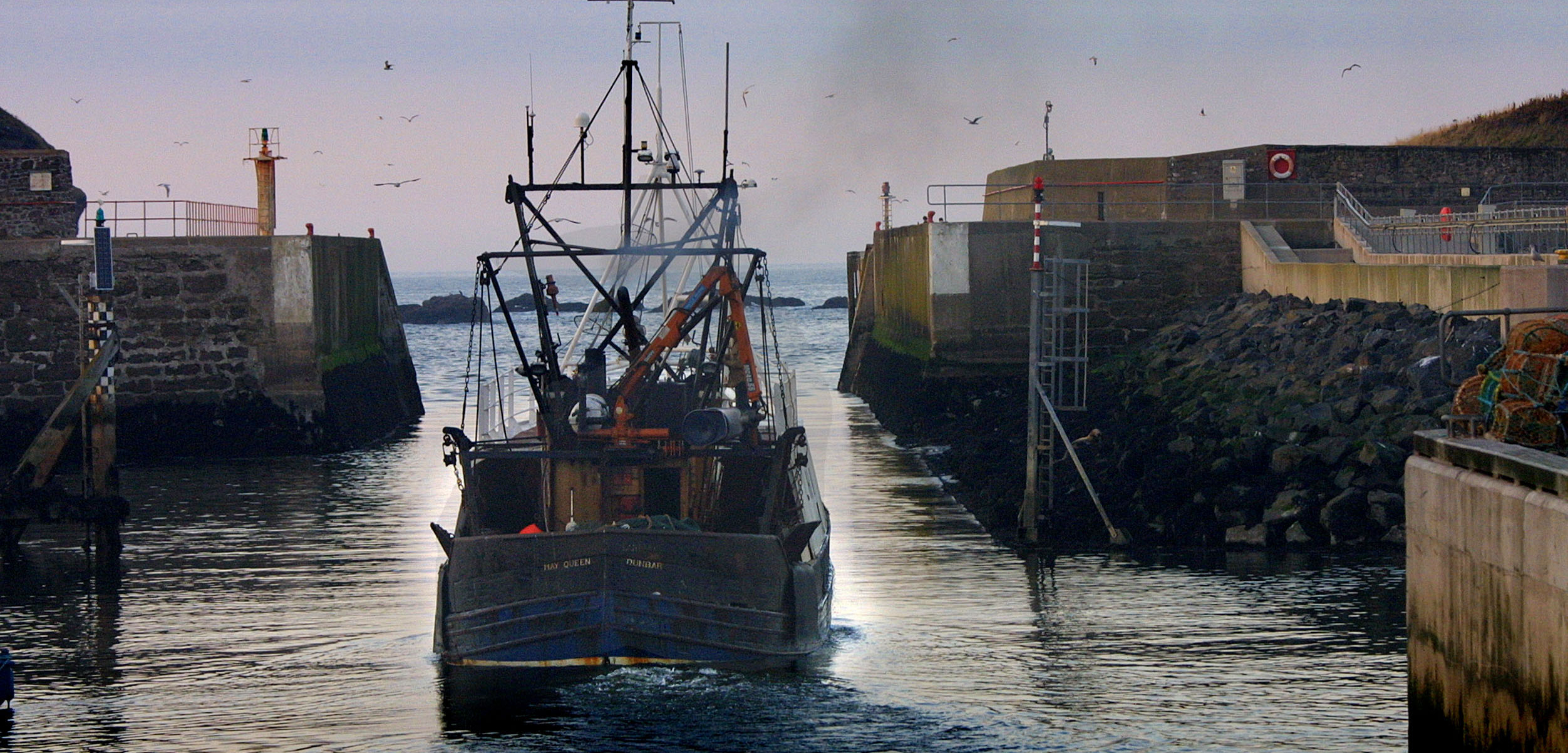 A fishing boat leaves from Eyemouth, Scotland, on October 31, 2002. Photo by Colin McPherson/Corbis
