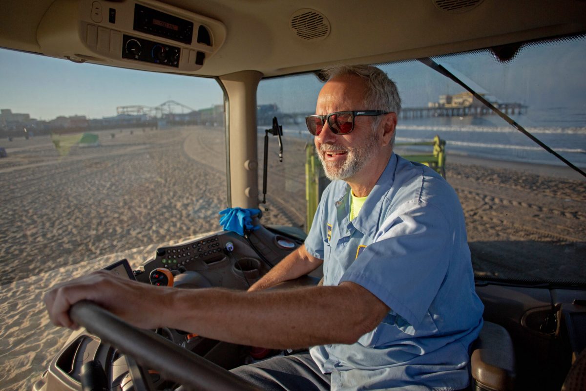 Gavin Andrus in the cab of his tractor grooming Santa Monica Beach