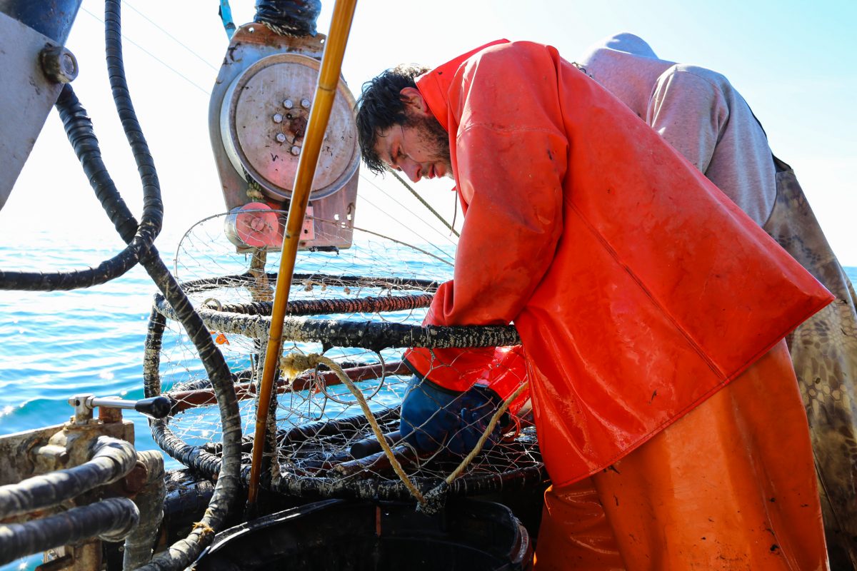 crabbing crew attach oxygen sensors to a crab pot