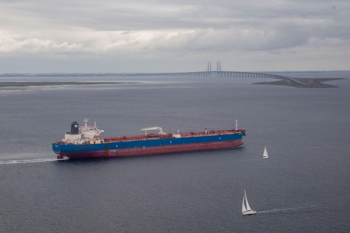A cargo ship cruises past the Øresund Bridge in Denmark