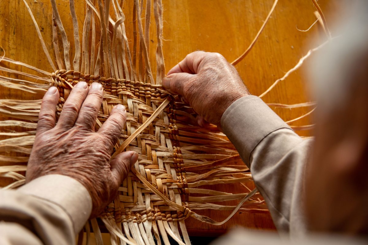 Ed Carriere weaving the base of a basket