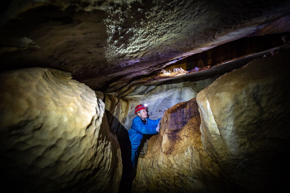 Scientist explores a cave.