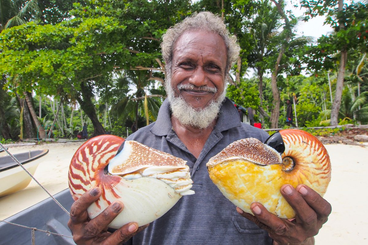 Chief Peter Kanawi holding nautiluses