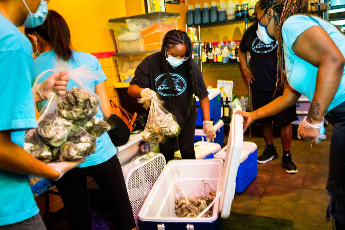high school students pack seafood in to coolers