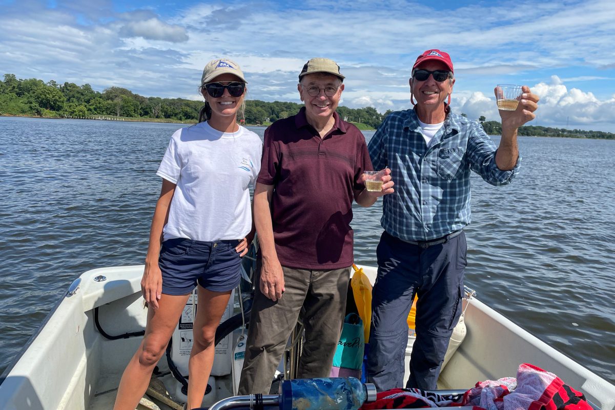 From left, Emi McGeady, Tom Guay, and Bob Agee, a sponsor of Operation Build a Reef, celebrate after an oyster planting in August, 2021