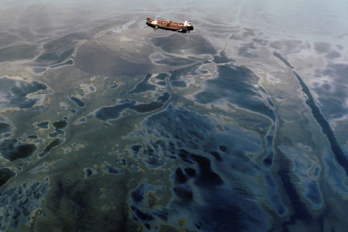 Exxon Valdez surrounded by oil from its spill