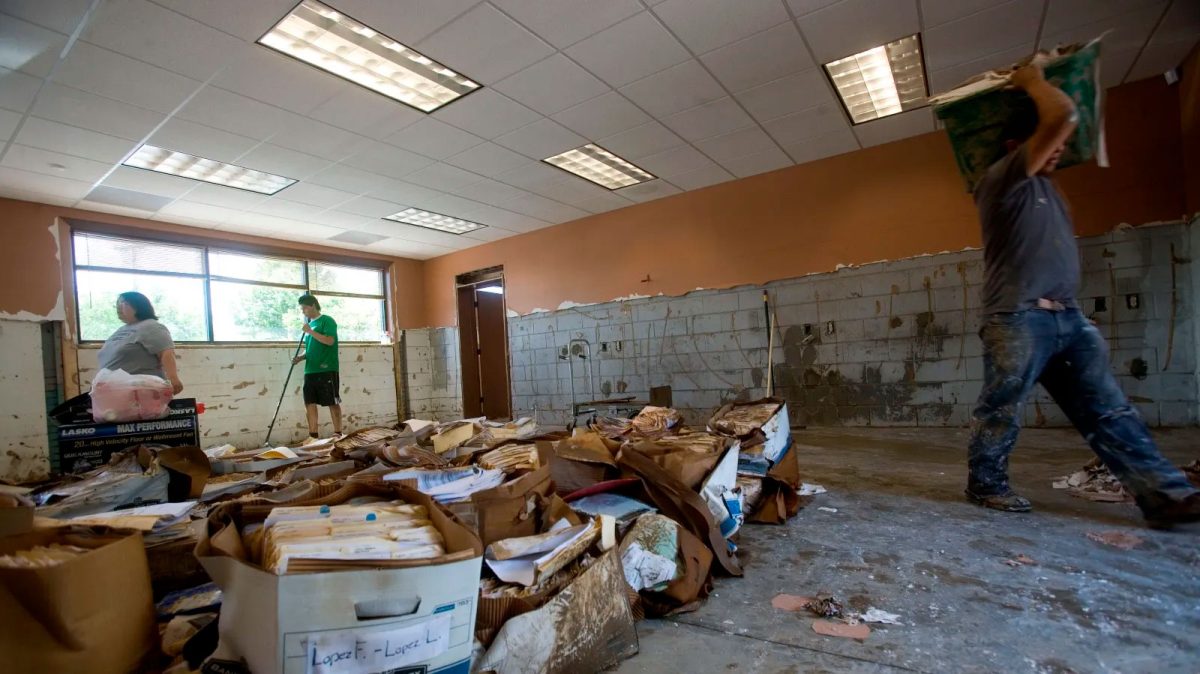 Workers clear debris and attempt to save client records at an insurance office in south Nashville, Tennessee