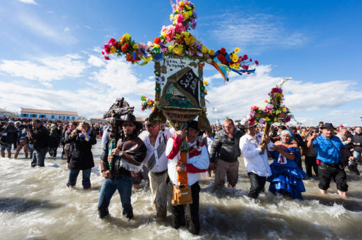 Led by people carrying crosses, thousands wade into the shallow waters off Saintes-Maries-de-la-Mer along with the statuette of Saint Sara. Photo by Atlantide Phototravel/Corbis