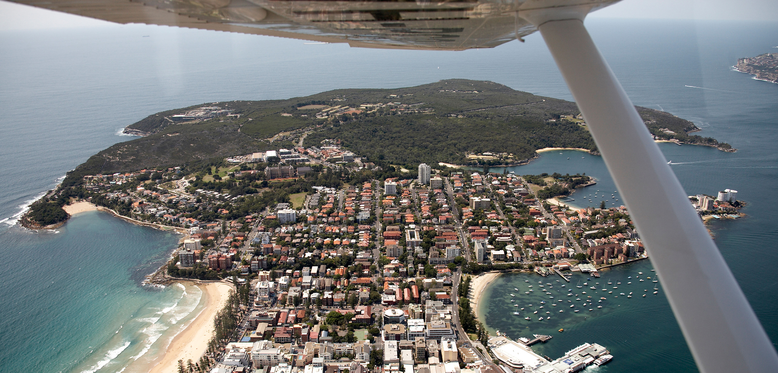 An aerial photo from a float plane of a city on a penisula.