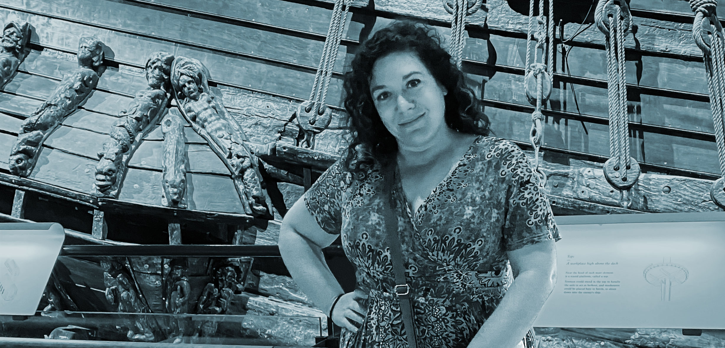 Rebecca Simon in front of a pirate ship exhibit at a museum