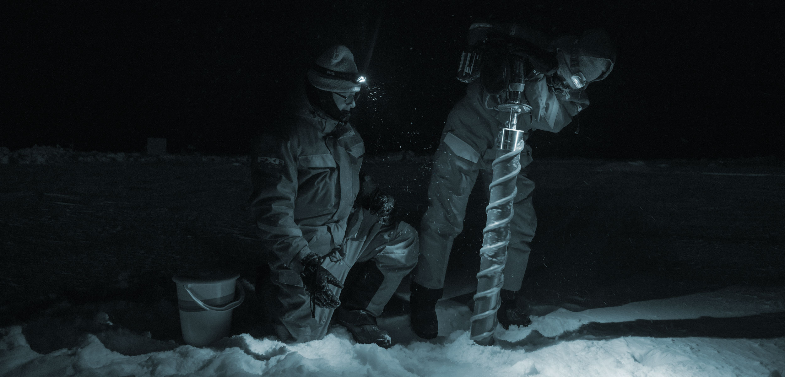 researchers drilling an ice core