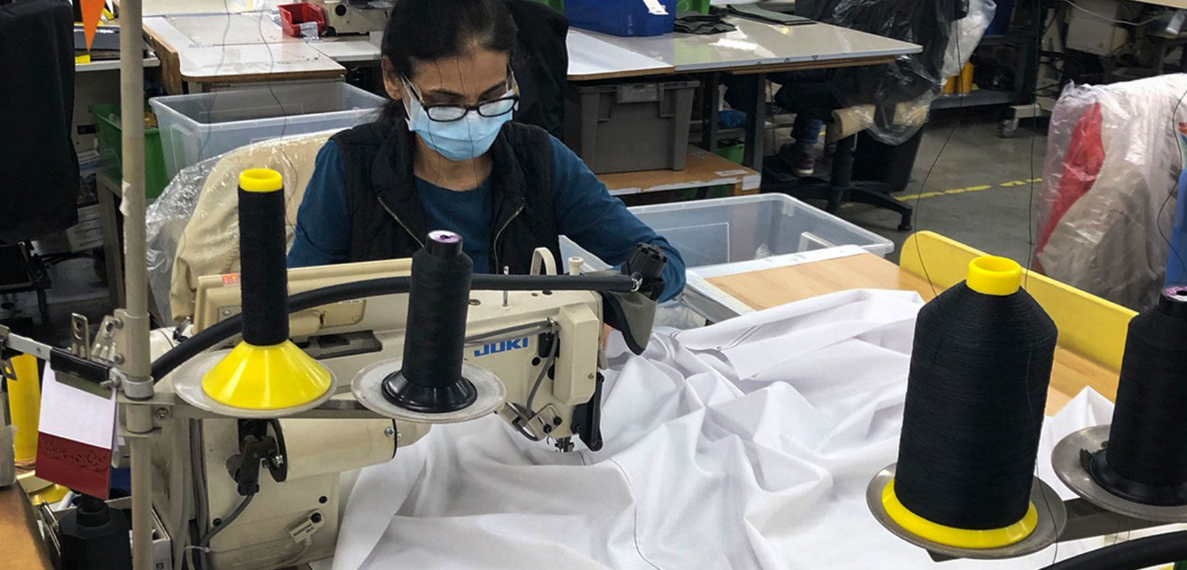 person sewing a medical gown