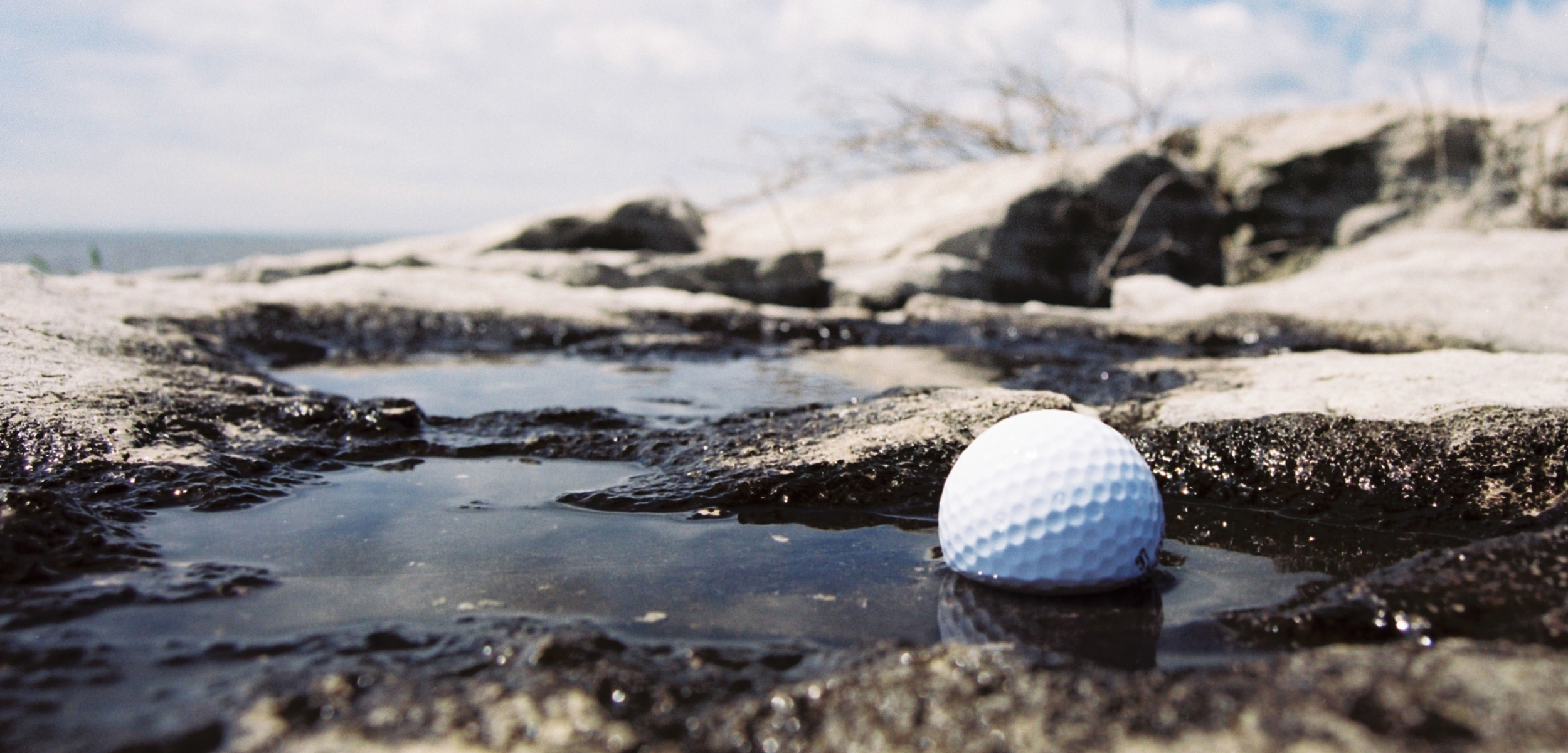 golf ball in water by the ocaen