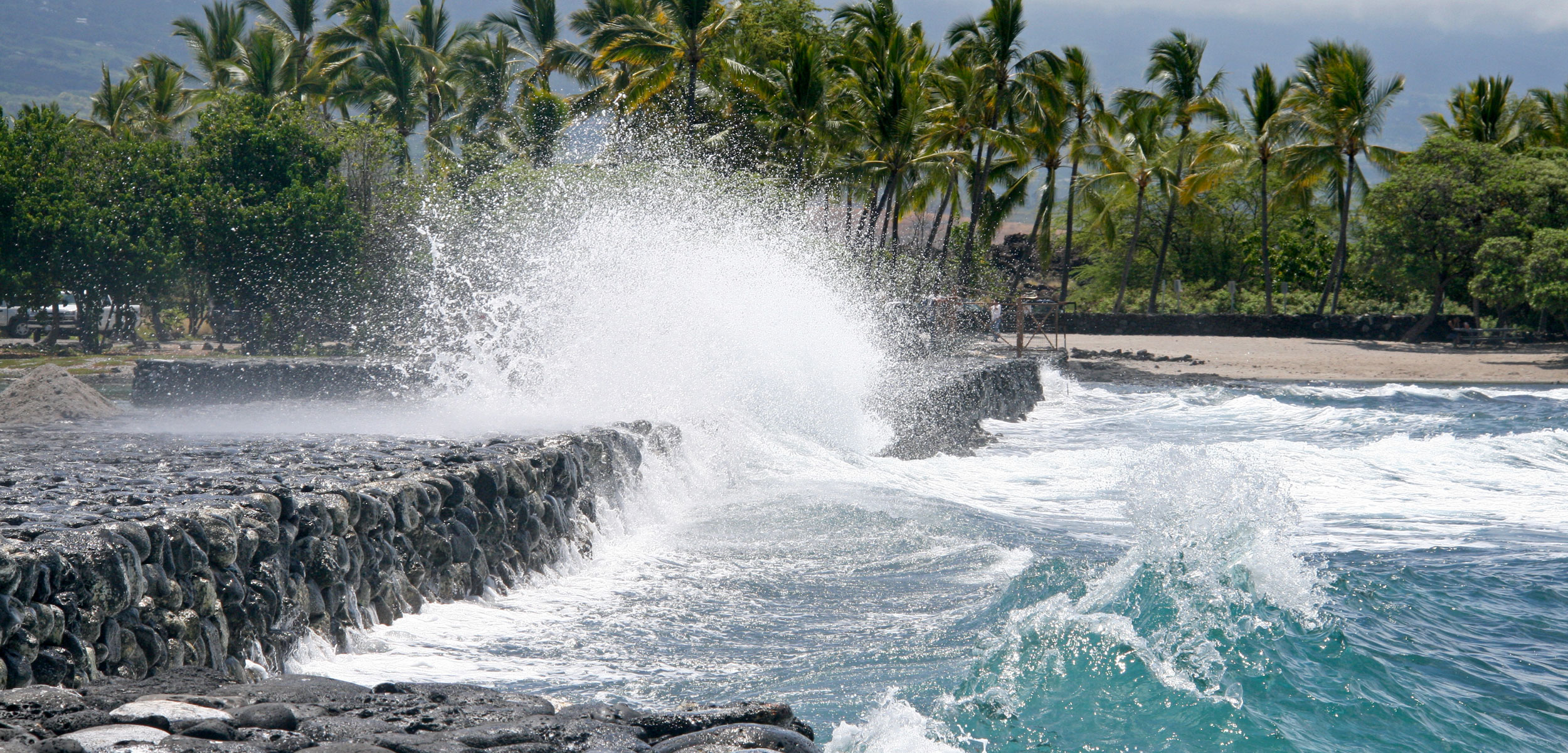 Pacific waves collide against the wall of the Kaloko fishpond on the Island of Hawai‘i