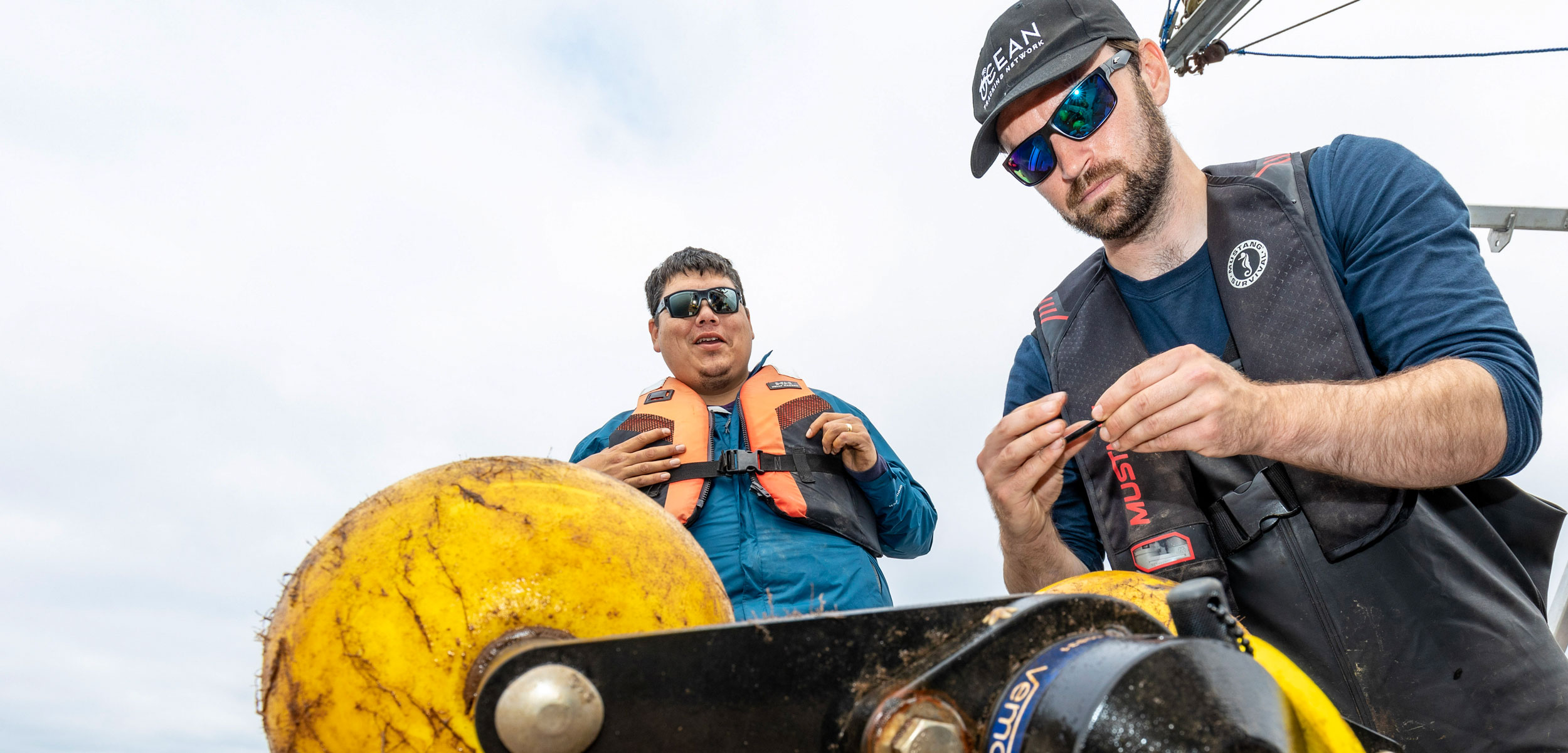 Team members from the Apoqnmatulti’k project in Nova Scotia, prepare to deploy an acoustic receiver in the Bras D’or Lake