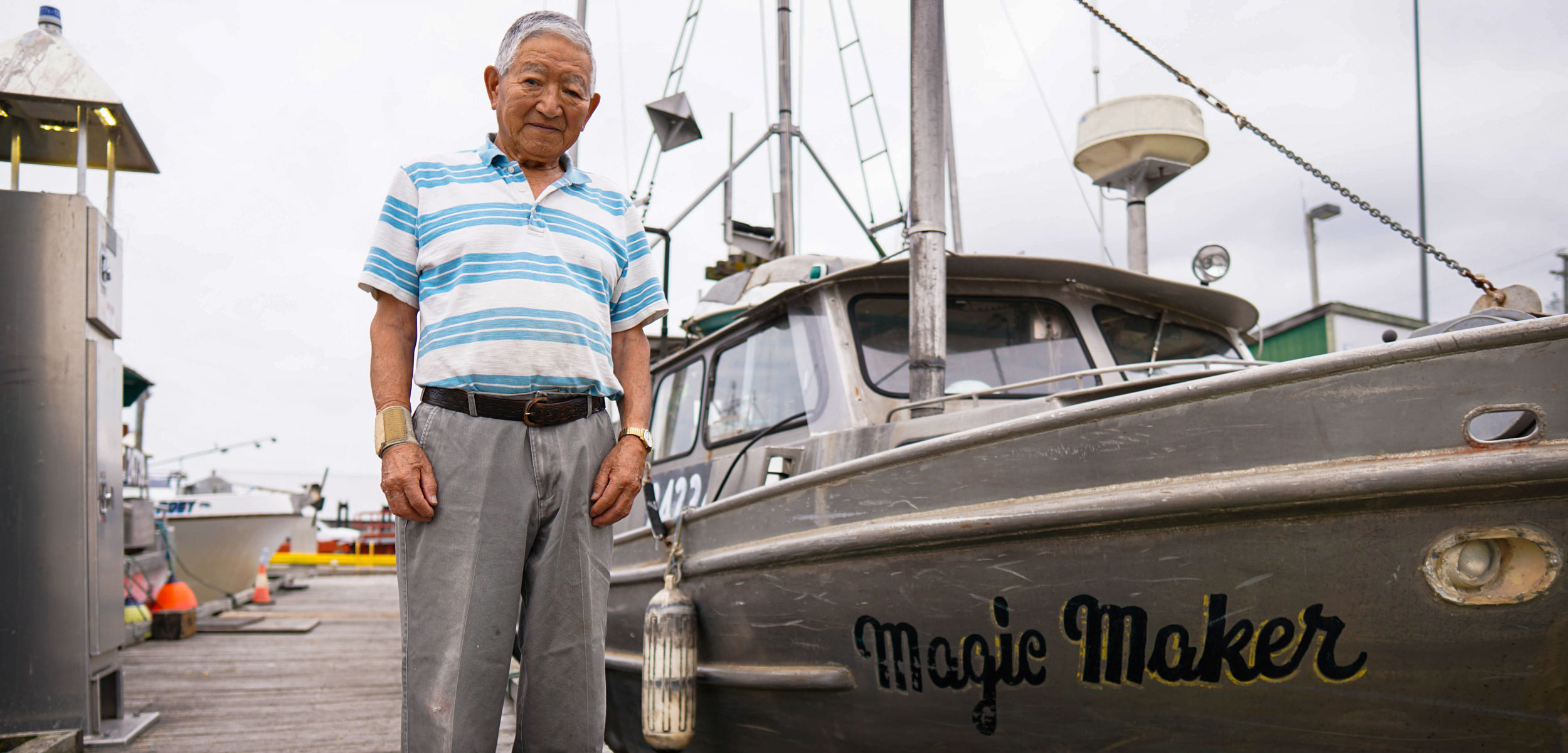Satoshi “Sugar” Hamada next to his boat