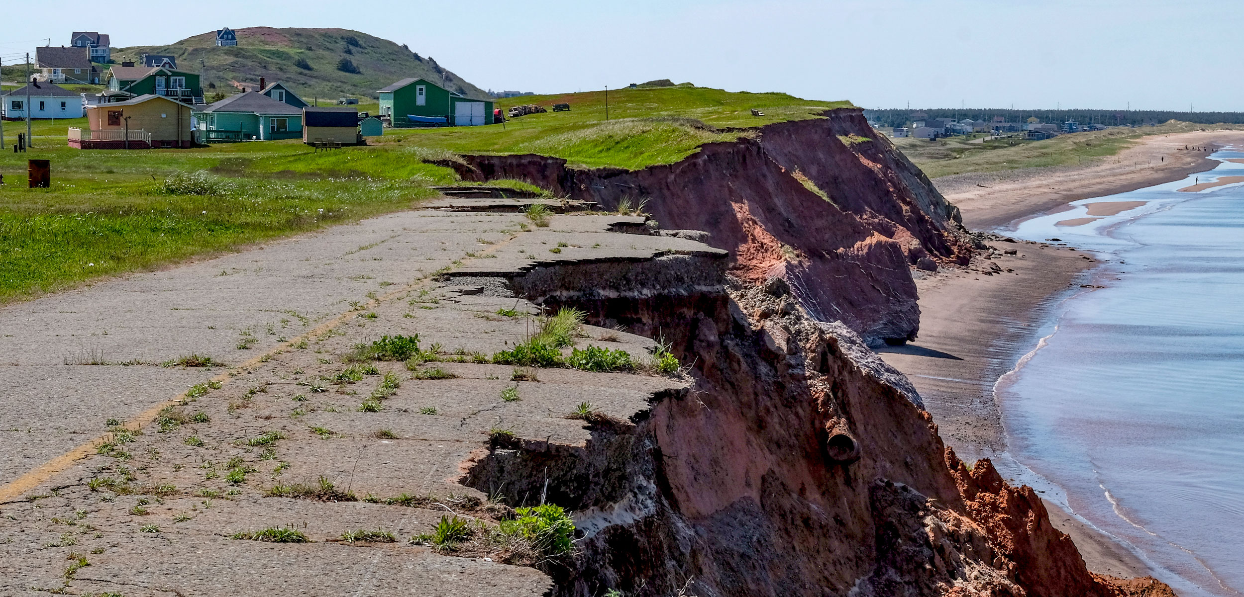 a cement path broken and eroded on a cliff in the Magdalen Islands, Quebec