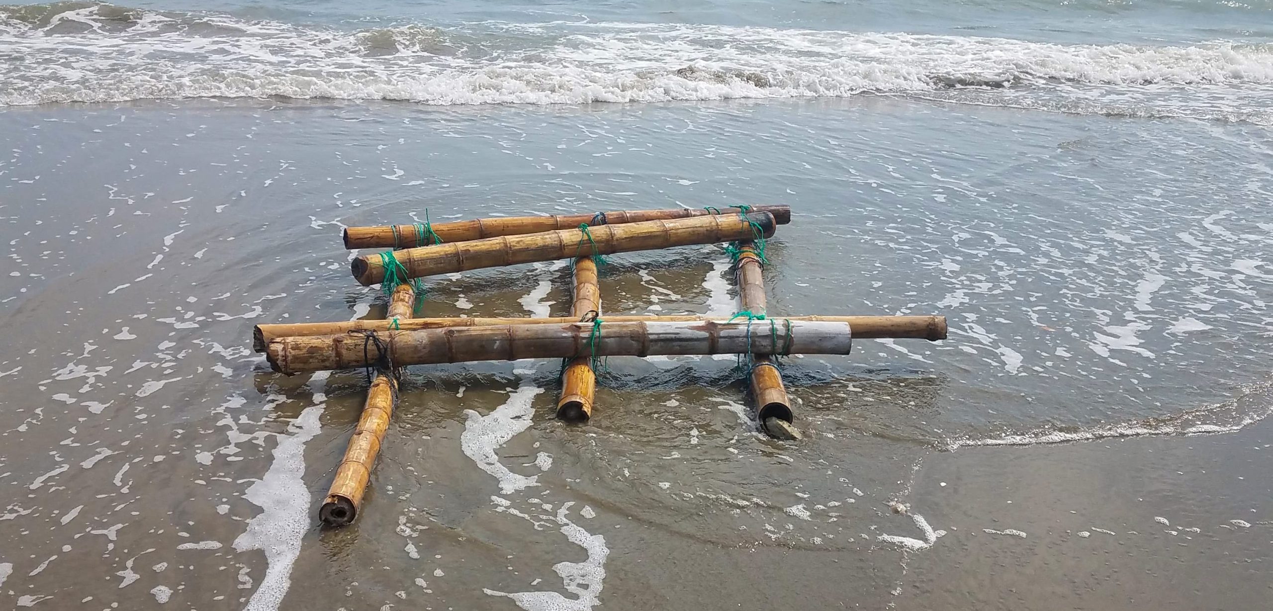 A bamboo fishing rig, approximately 1.5 meters by two meters, washes onto the beach of Posorja, Ecuador. Photo by Juan José Alava