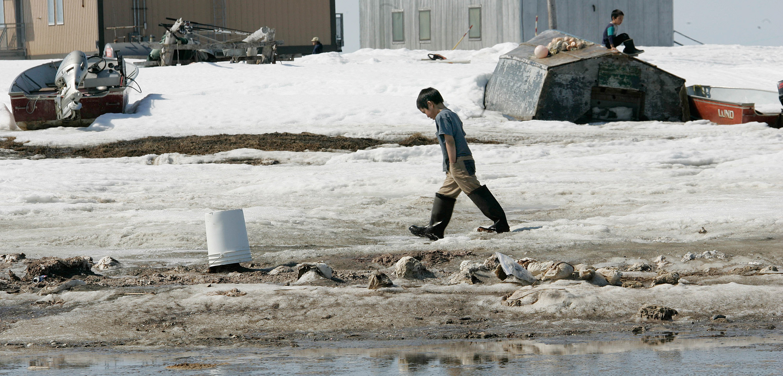 As the land erodes around them, the villagers of Newtok, Alaska, struggle to relocate their community. Photo by Al Grillo/AP Images