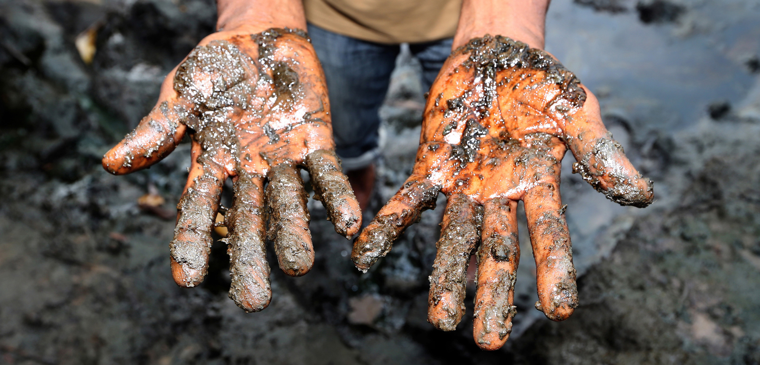 muddy oil on hands