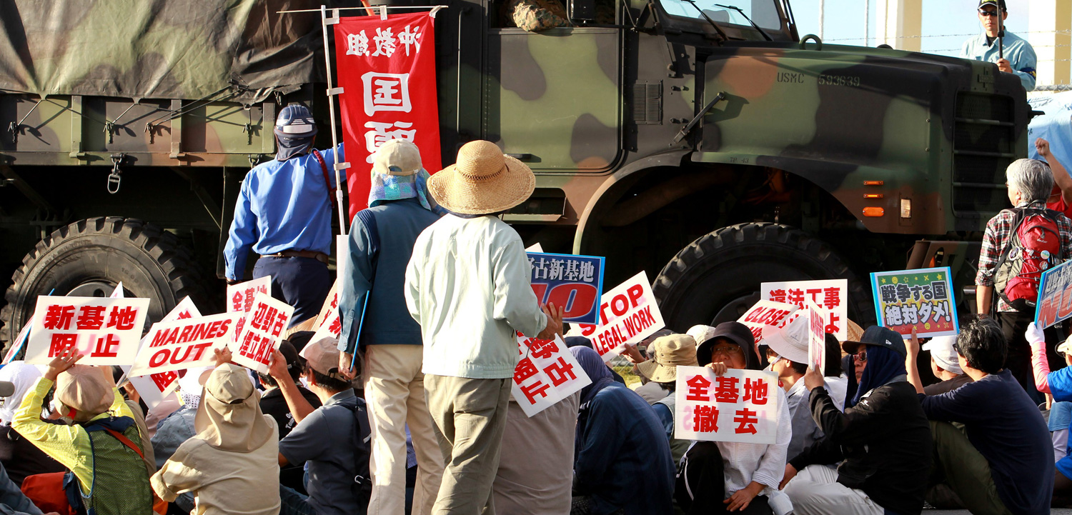 Demonstrators at Camp Schwab, a US military base on the island of Okinawa, Japan, want the world superpower to back off their land. Photo by Hitoshi Maeshiro/epa/Corbis