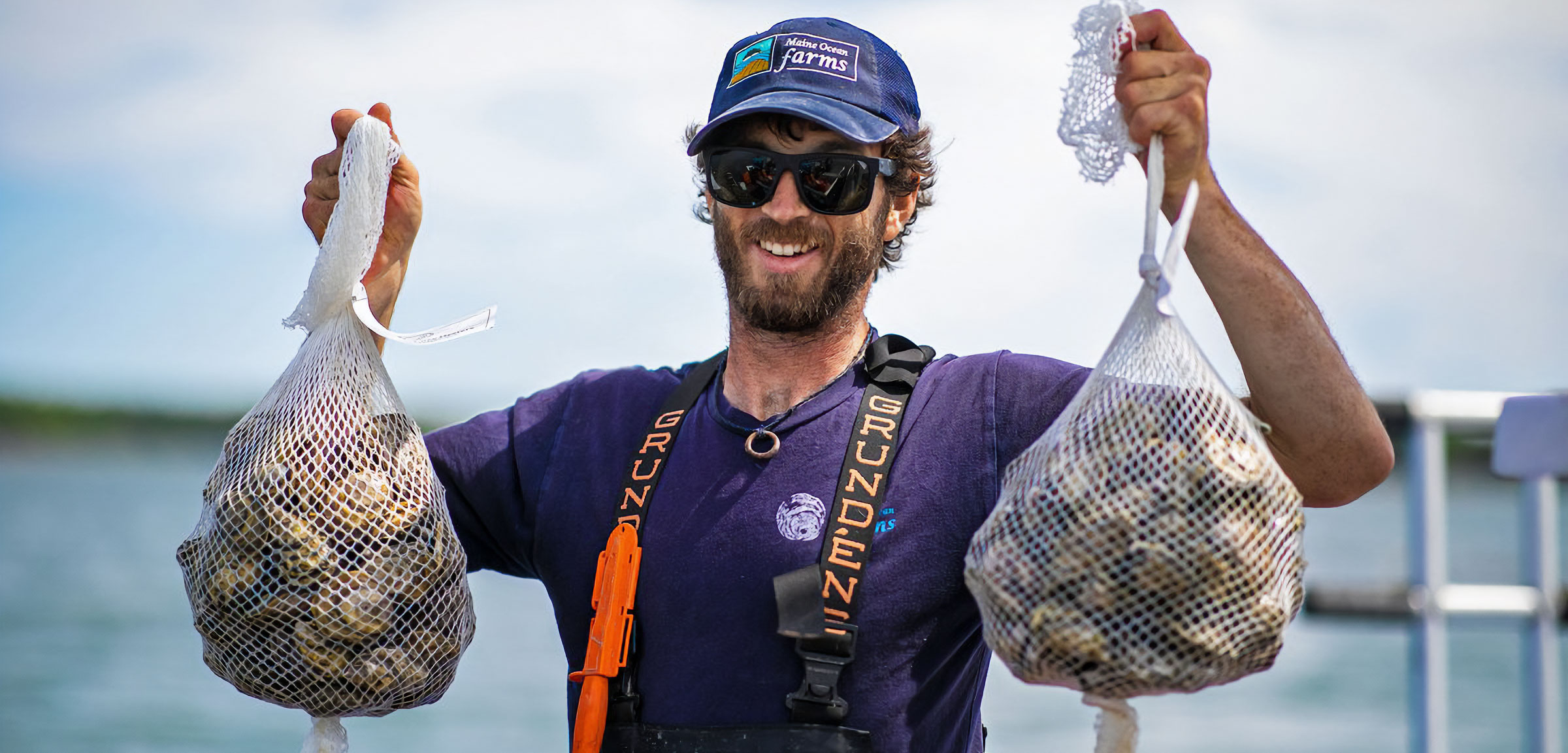 Eric Oransky, founding partner, Maine Ocean Farms, holds up two beechwood oyster harvest bags