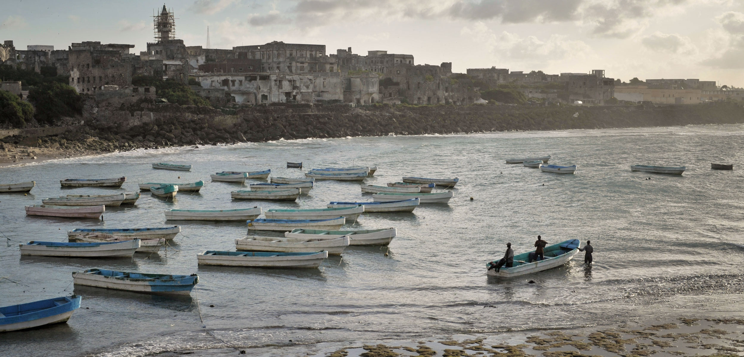 Fishing boats in Mogadishu's old port in Somalia at sunrise