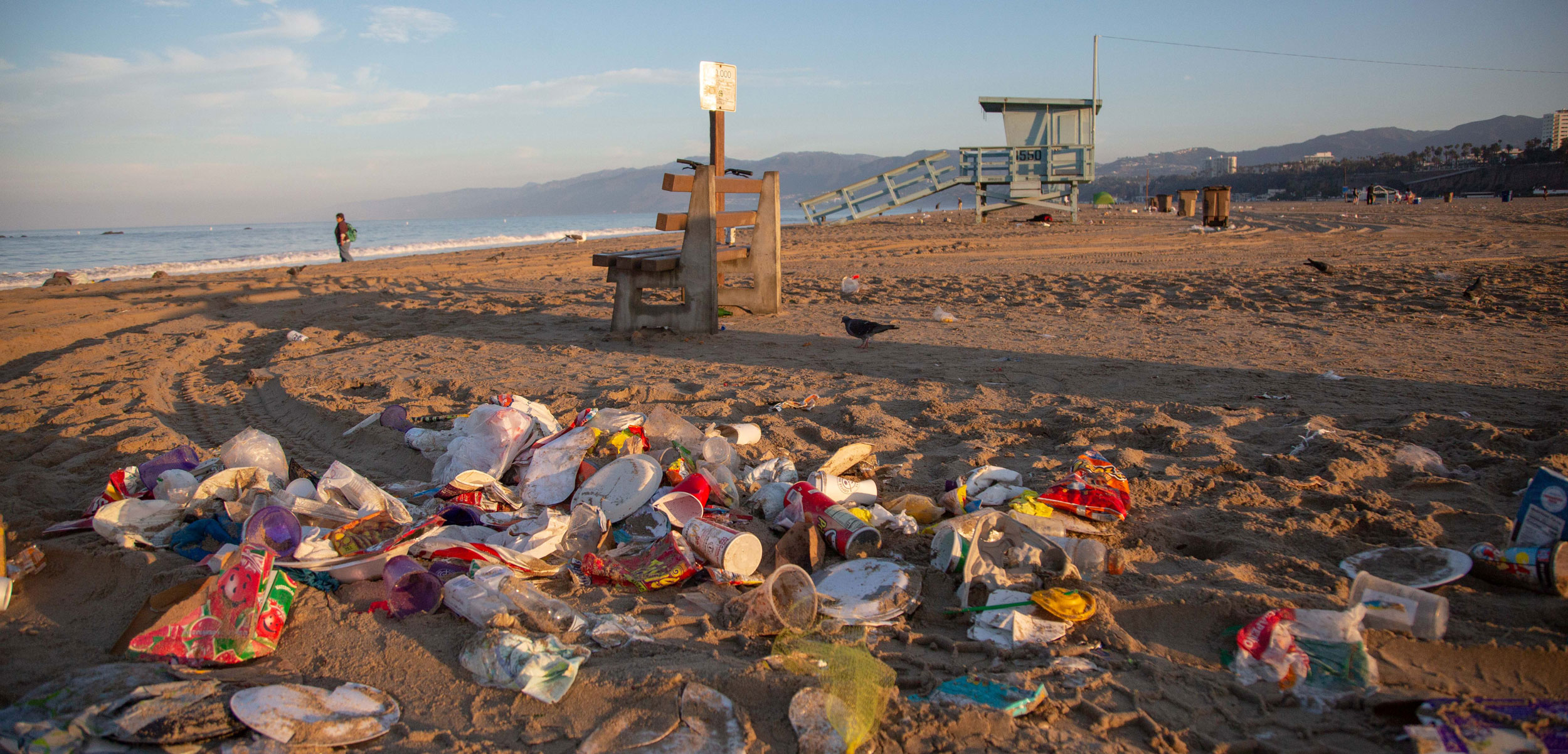 Piles of trash at sunrise on Santa Monica Beach, California