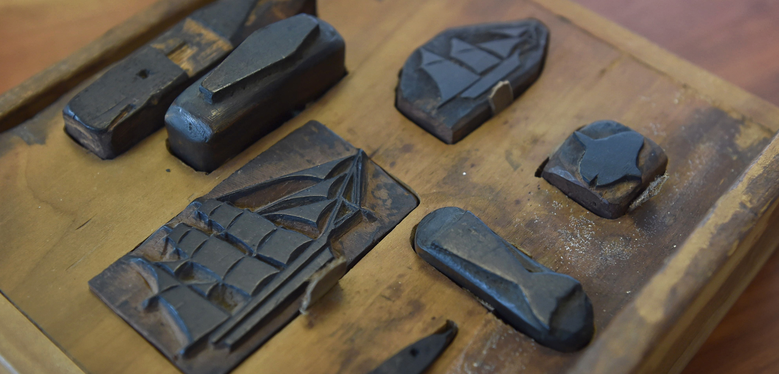 This collection of seven stamps is one of the most elaborate examples of carved stamps used by 19th-century whalers to record details of their voyage. The set includes a whale, a three-masted bark, a schooner, a whale’s flukes, an unidentified cetacean, a sunfish, and a coffin. Photo by Nelson Mare