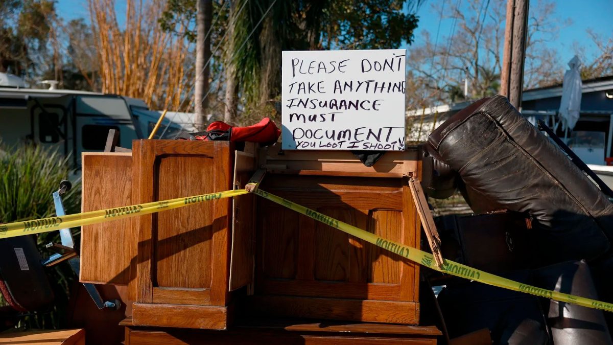 A sign in Fort Myers, Florida, warns passersby to leave damaged home furnishings alone following Hurricane Ian in October 2022