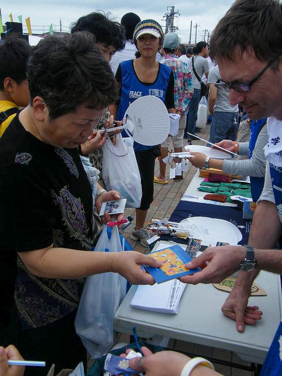 Peace Boat volunteers present survivors in the city of Ishinomaki with Tsunamika dolls