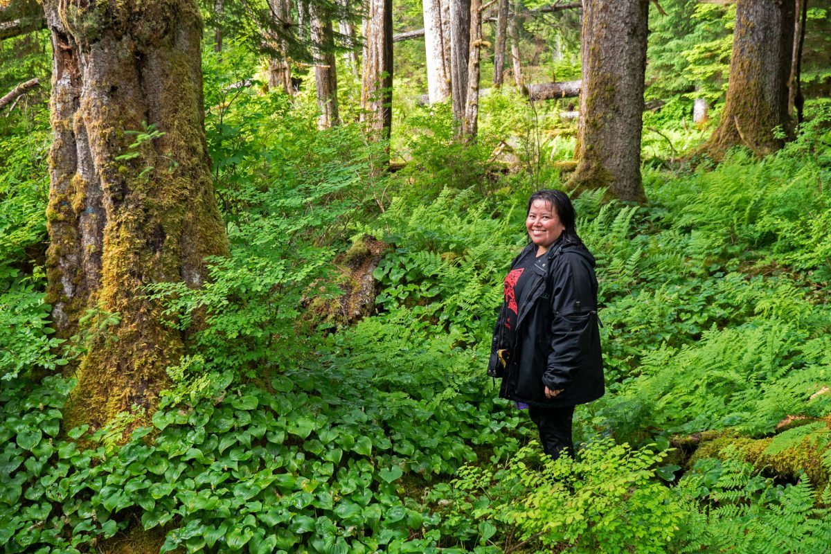 Jennifer Walkus, a member of the Wuikinuxv Nation’s bear working group, hikes through the woods in the nation’s territory.