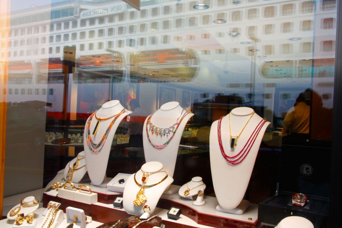 jewelry in shop window with reflection of cruise ship
