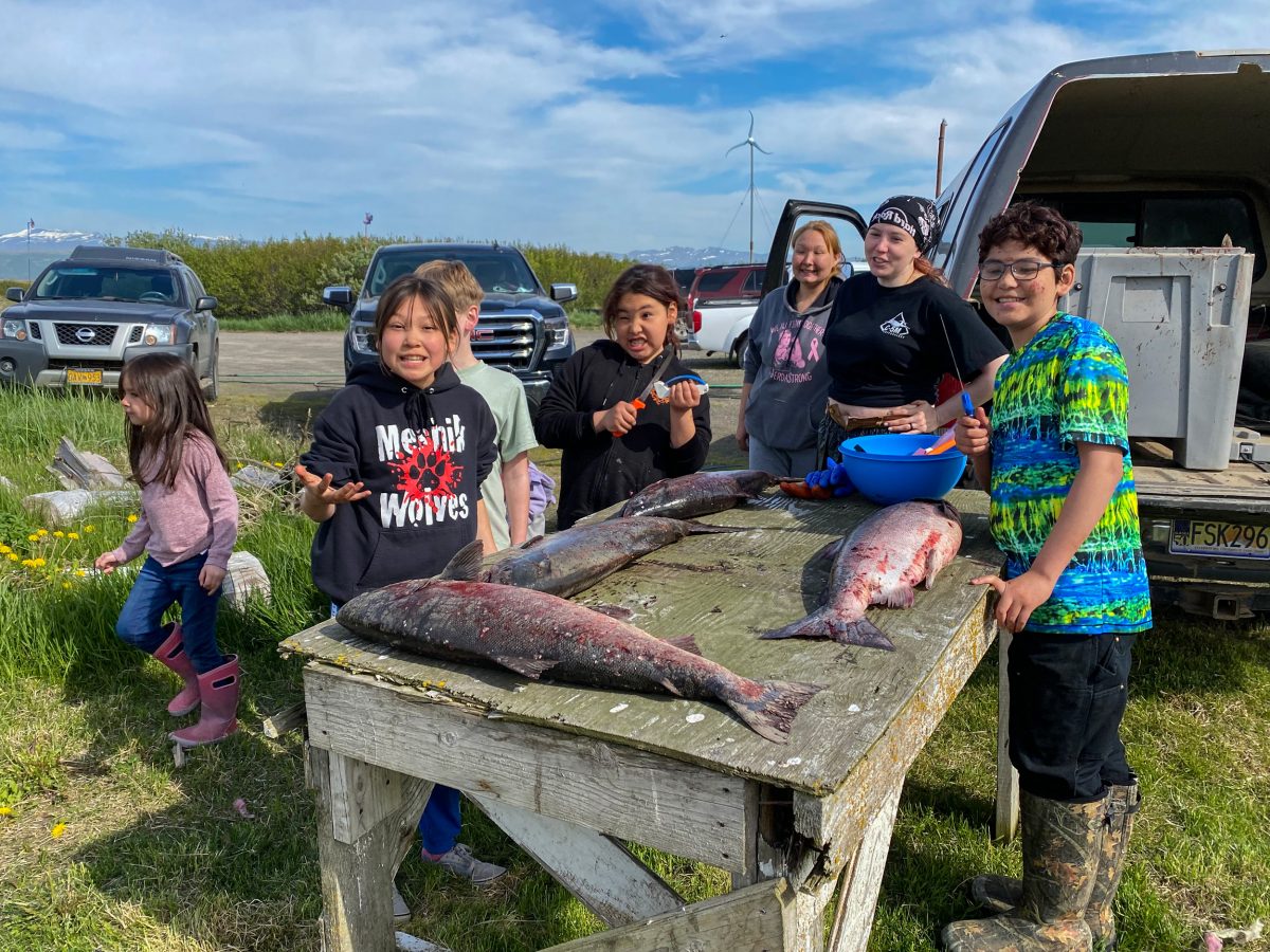 In Port Heiden, Alaska, young workers get ready to head, gut, and filet king salmon, a task that brings the entire family together.