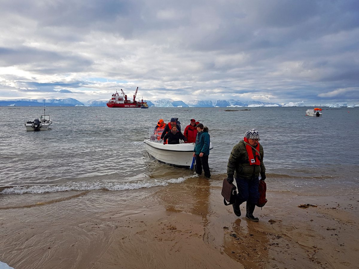 Members of the Pikialasorsuaq Commission are shuttled ashore to attend a meeting in Qaanaaq, Greenland. Photo by Christopher Debicki