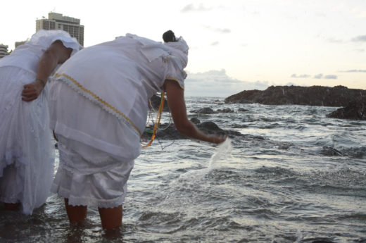 Women in Salvador, Brazil, visit the ocean early in the morning, before the Festival of Iemanjá gets underway. Photo by Mauro Akin Nassor/Fotoarena/Corbis