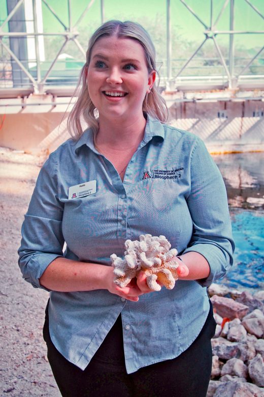 Katie Morgan, manager of marine systems at Biosphere 2, holds a dead piece of coral left over from earlier research in the replica ocean. 