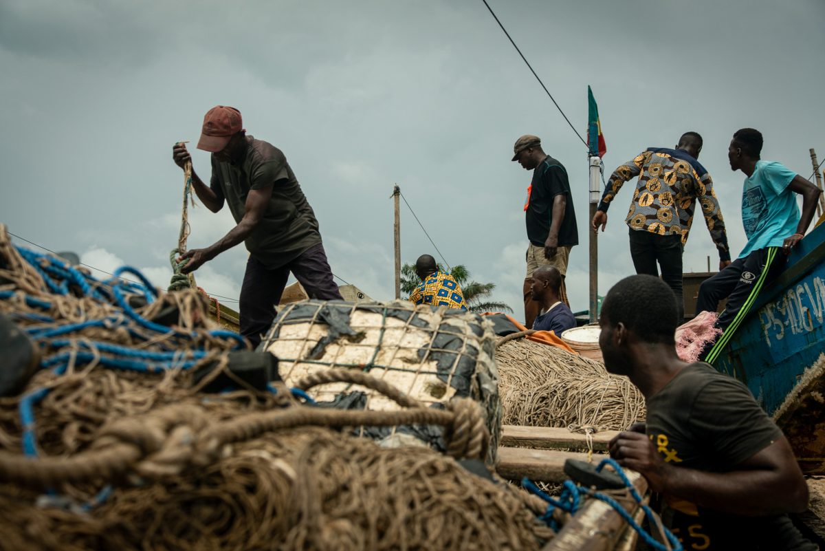 Pangou (left) and his Congolese crew prepare a pirogue to head out to sea. 