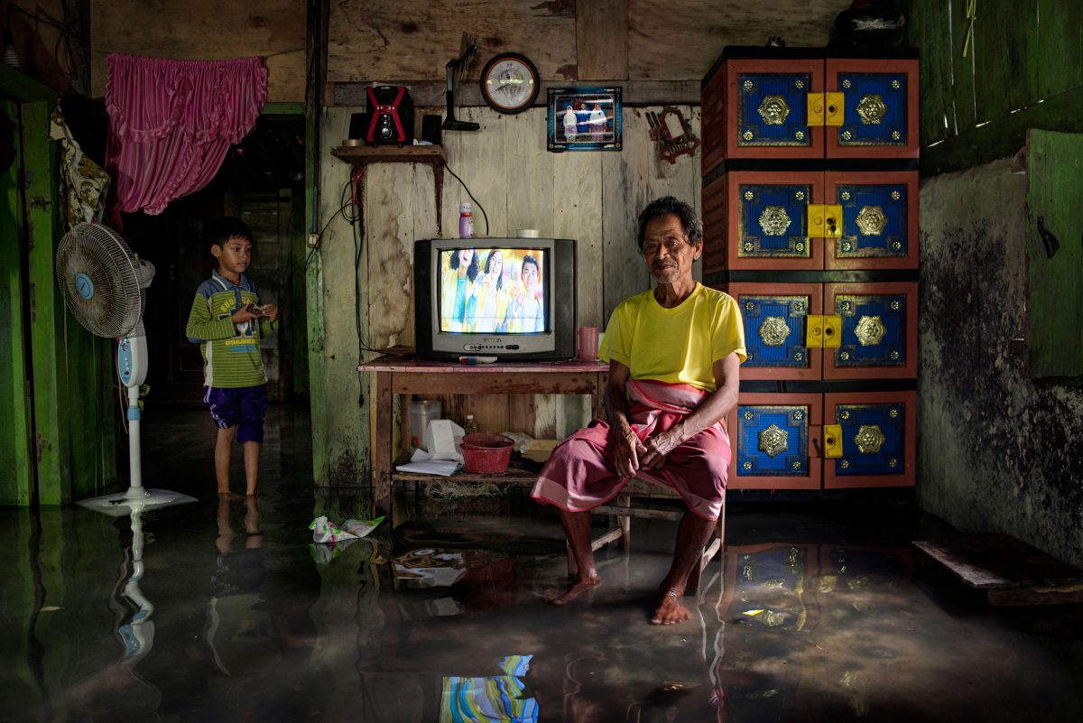 people in a flooded home on Indonesia