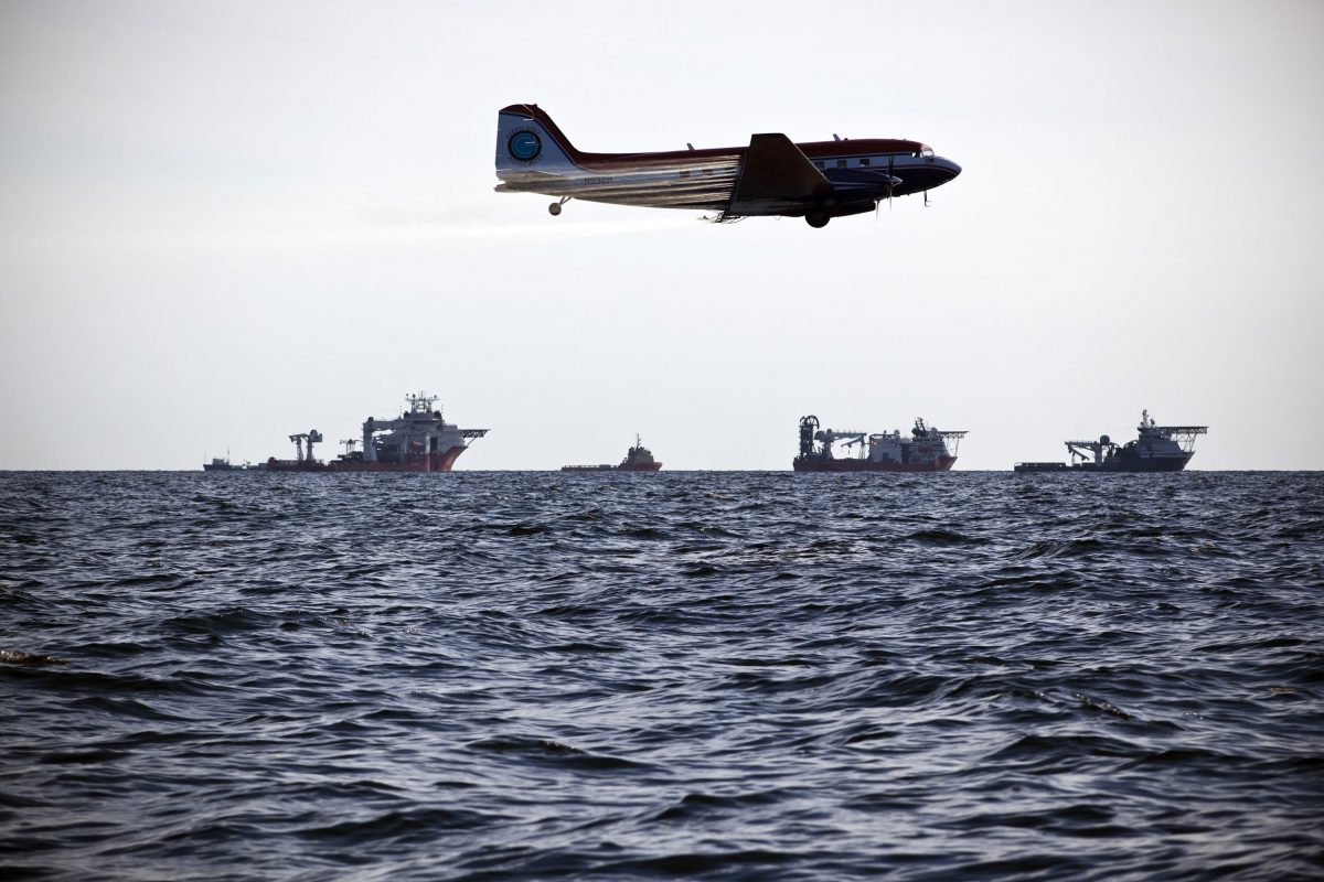 Plane sprays chemical dispersant over oil-covered Gulf of Mexico waters after Deepwater Horizon water leak