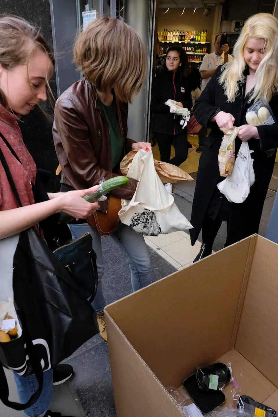 Shoppers leave excess packaging at the entrance to a Brussels, Belgium, supermarket