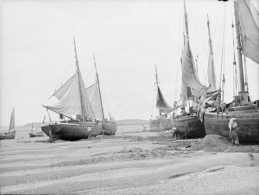 Ships aground at North Devon, England, circa 1900, take on sand and gravel as ballast. Photo courtesy of the National Maritime Museum, Greenwich, London