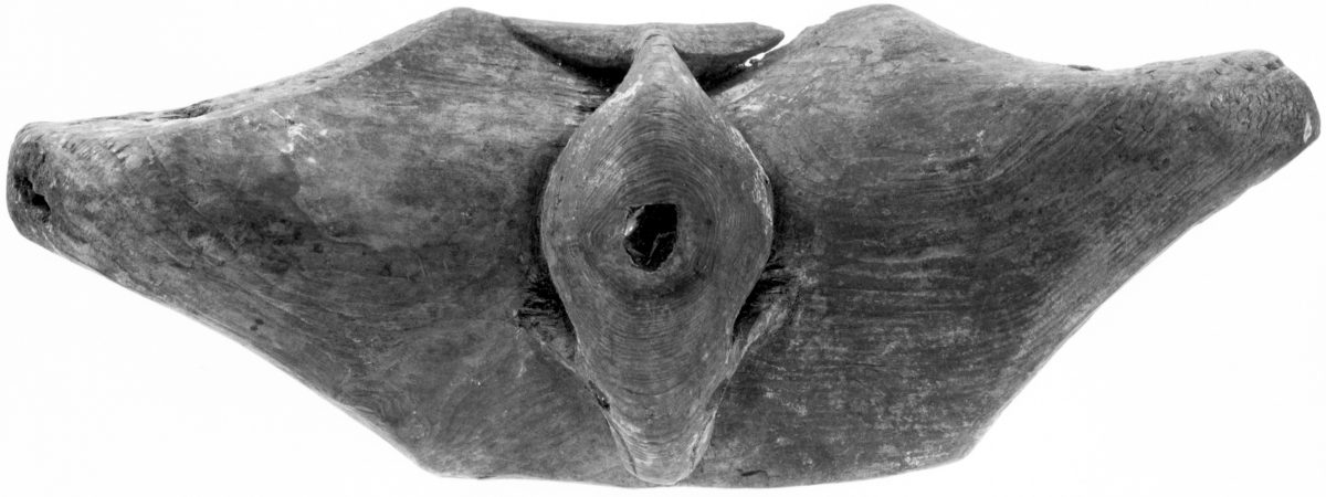Sometime in the late 19th century, an Iñupiat carver fashioned this seat for an umiak out of driftwood, carving the likeness of a bowhead whale, its blowhole symbolized with a piece of obsidian. Photo by Department of Anthropology, Smithsonian Institute (Cat. A347918)