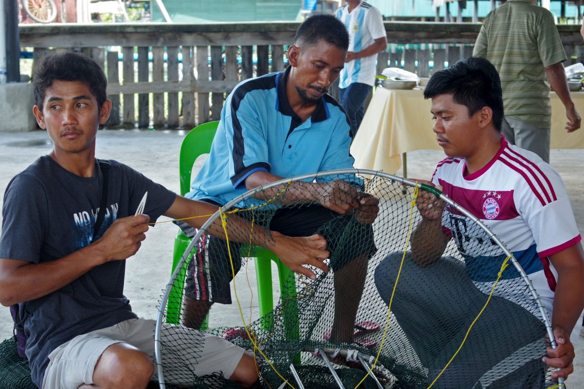 Fishermen at a Marine Research Foundation workshop in coastal Sabah, Malaysia, build a turtle excluder device