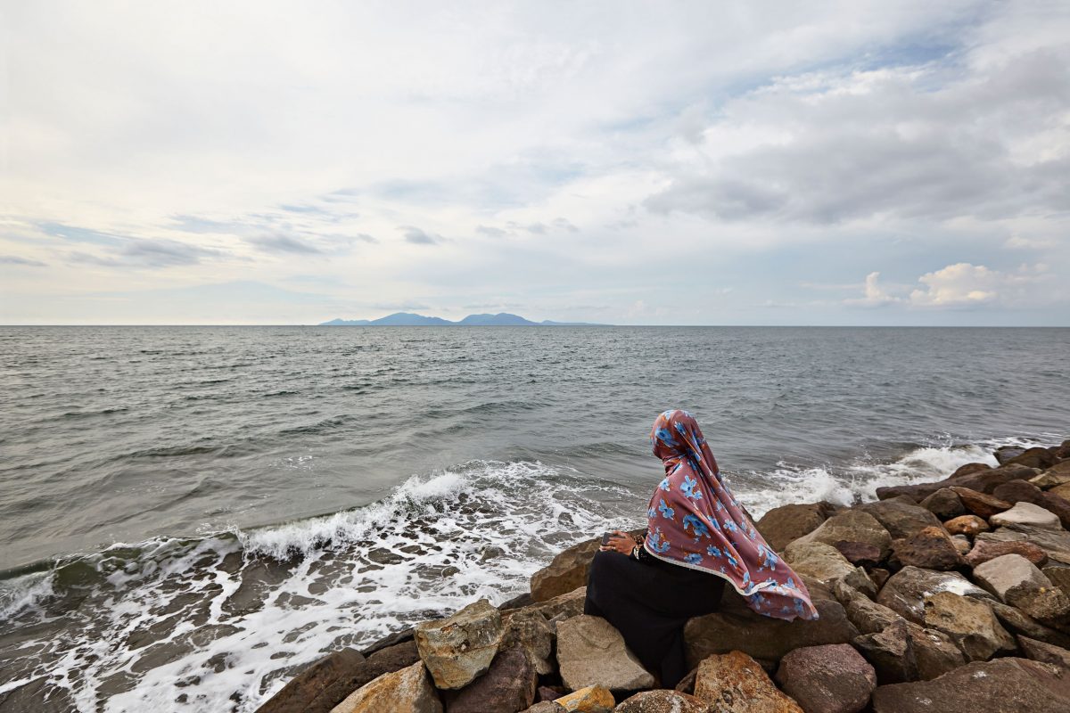 A woman gazes out at the Indian Ocean from the Indonesian province of Aceh, nearly 15 years after a tsunami devastated the region.