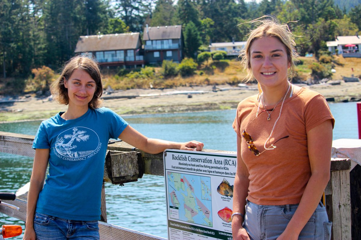 Ankenman and Jenna Falk, past development coordinator with the Galiano Con-servancy Association, stand near one of their educational signs on a Galiano Island wharf.