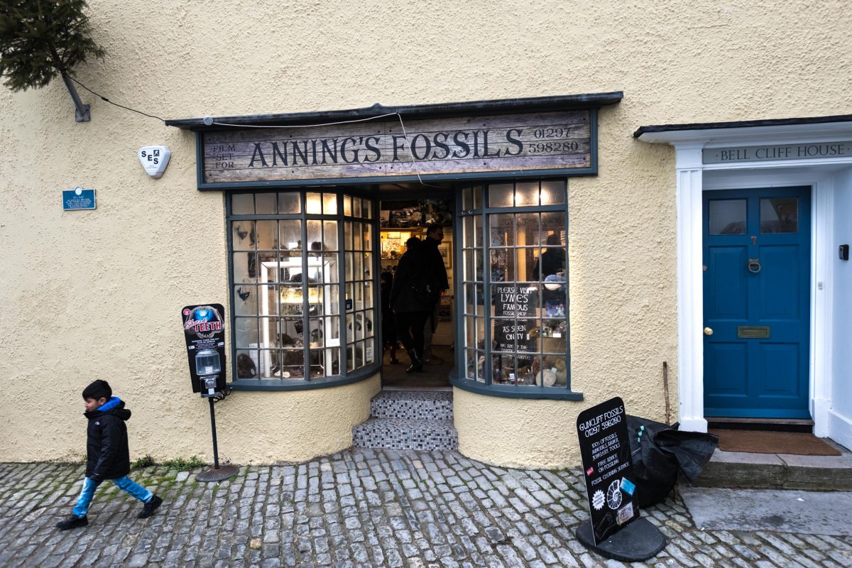A boy walks out of a fossil and curio shop owned by longtime collector Barry Titchener. The shop was used as the setting for Mary Anning’s fossil business on the set of the upcoming biopic about the Lyme Regis–based fossil collector. Her actual shop was situated just across the street.